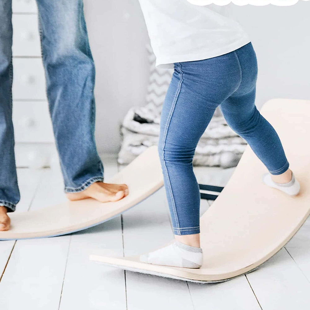 Children standing and balancing on curved wooden balance boards for sensory play.