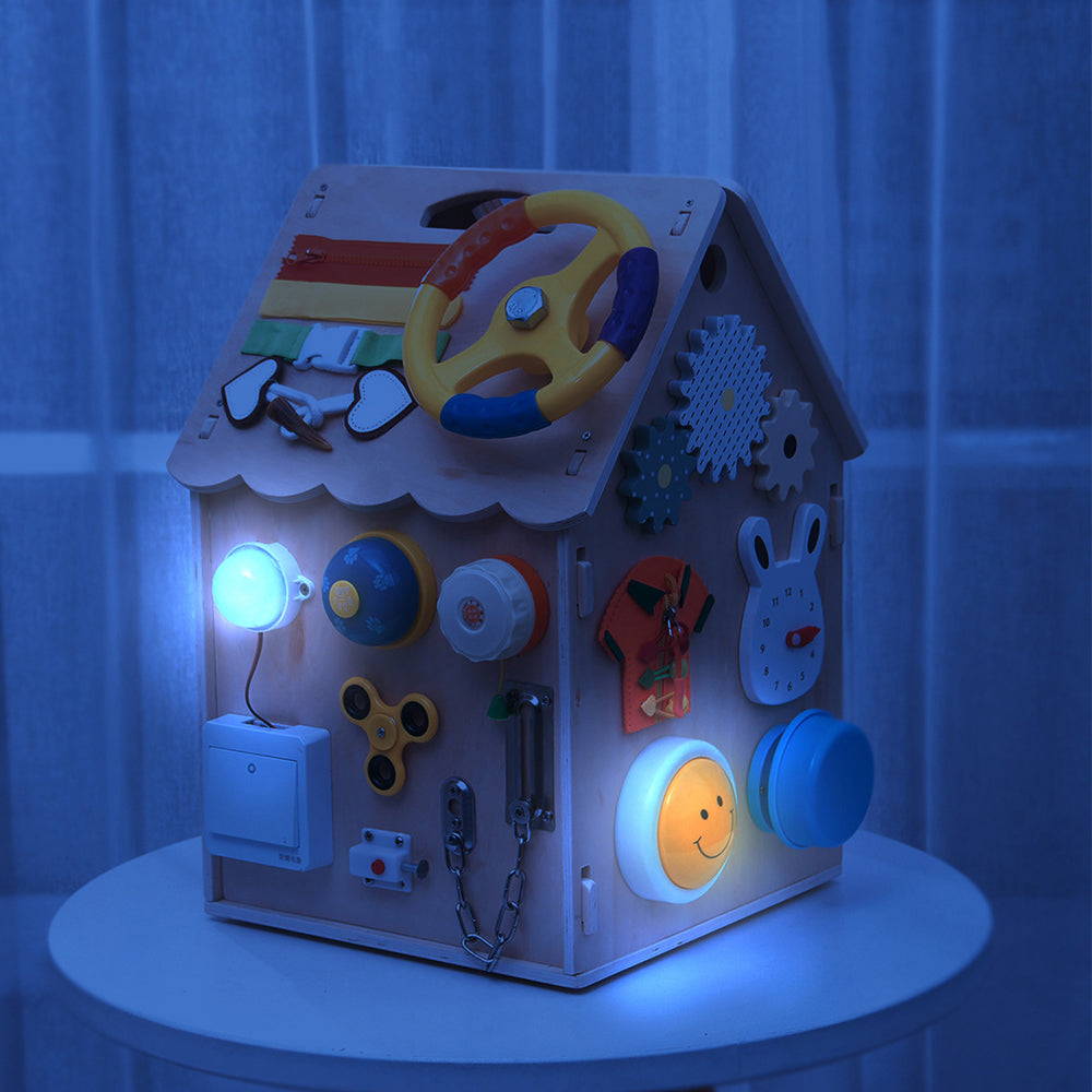 Montessori busy house at night with glowing lights and interactive sensory features