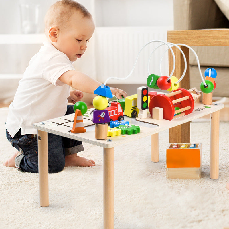 Toddler playing with jollychest Montessori Busy Table – Wooden Activity Table with Cars and Beads